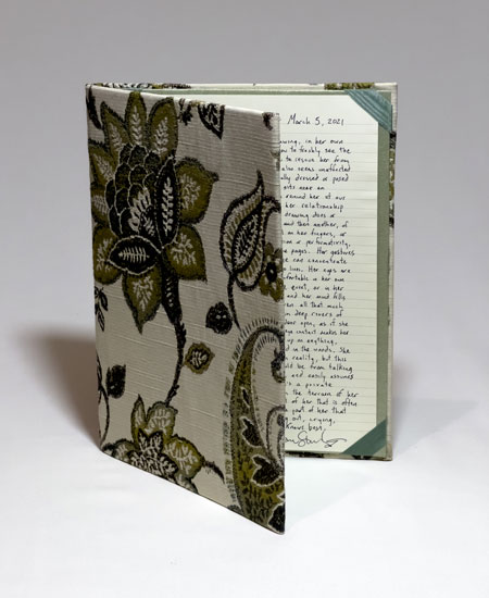 A written portrait by Jason Stoneking in a flowered green folder