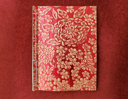 A red and gold Bespoke Book by Jason Stoneking