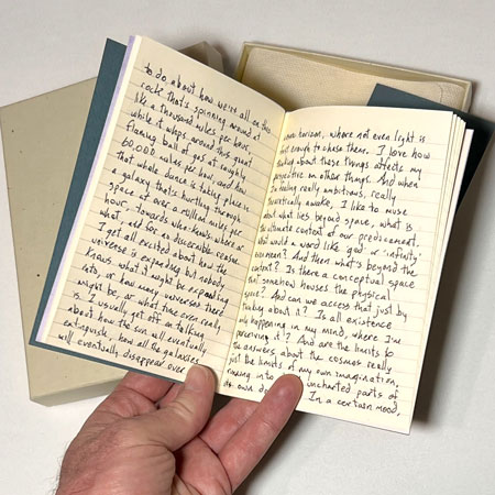 Jason Stoneking holds open one of his Bespoke Books