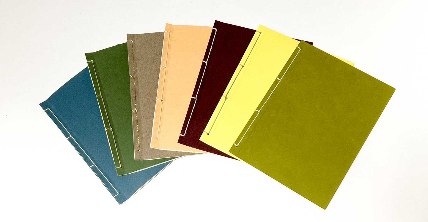 A colorful arrangement of several Bespoke Books by Jason Stoneking