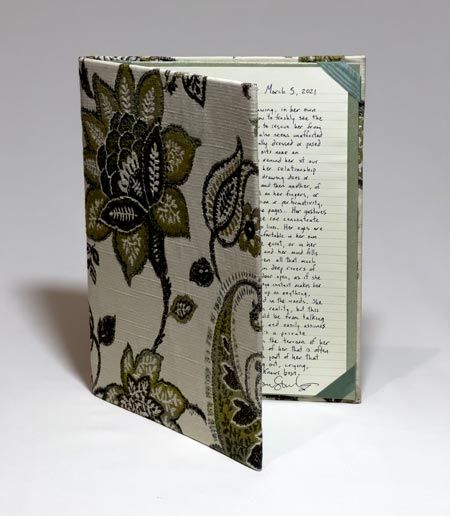 A handmade folder containing a written portrait by Jason Stoneking