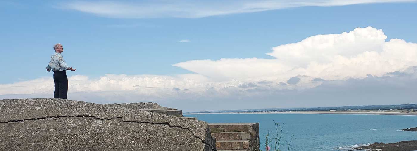 Jason Stoneking beholding a panoramic view of the sky over Granville, in Normandy
