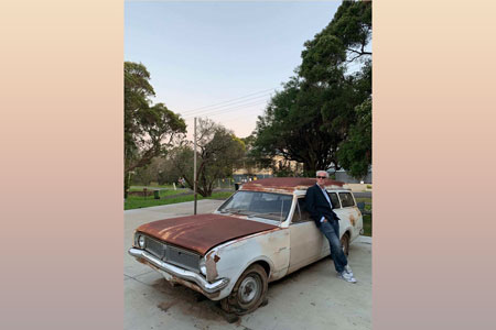 Jason Stoneking leans against an old car outside SeeSpace in Lismore, Australia