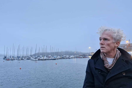 Jason Stoneking looking out over the water in West Cork photographed, by Catherine Ronan